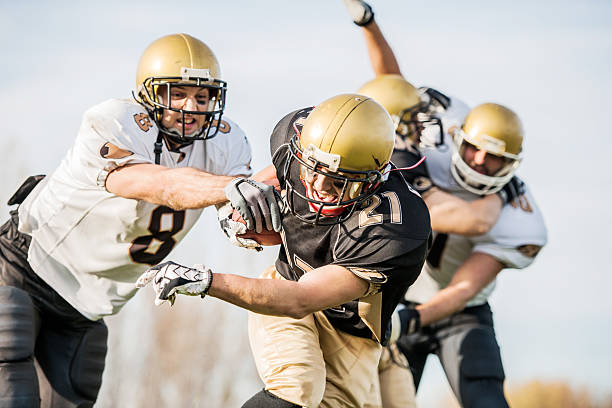 istock College Football - Catch and Tackle. 468376530