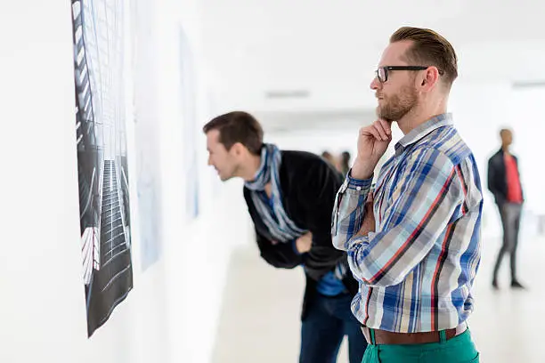 Photo of Visitors Looking At Artwork