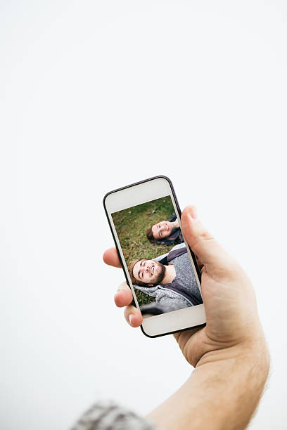 istock Two friends taking a selfie on a cell phone 468376748