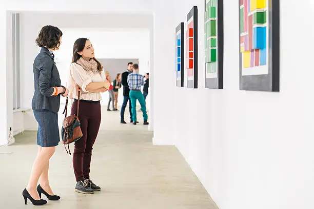 Photo of People In Art Gallery Looking At Artwork