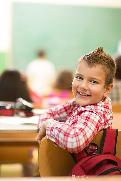 istock Happy schoolboy turning towards the camera at school. 468379726