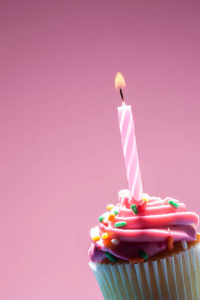 istock Birthday cupcake on pink background 468380356