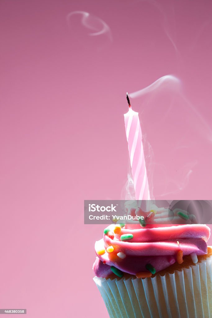 Birthday cupcake on pink background Macro shot of birthday cupcake with copy space 2015 Stock Photo