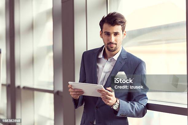 Elegant Businessman Using Digital Tablet Stock Photo - Download Image Now - Digital Tablet, Elegance, Holding