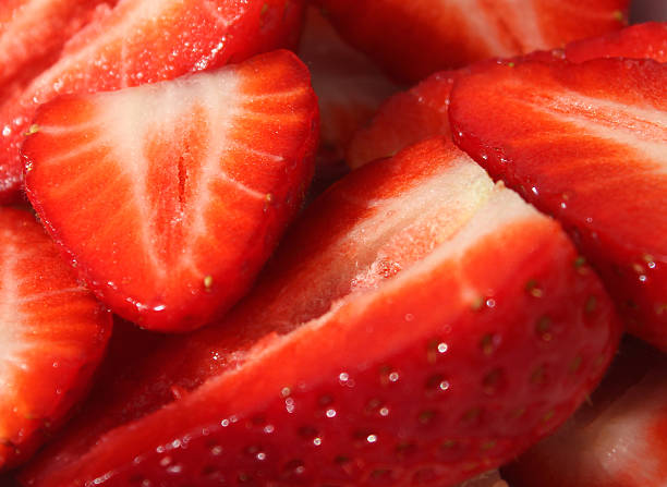 istock Image of sliced strawberry halves in dish, summer fruit / berries 468385384