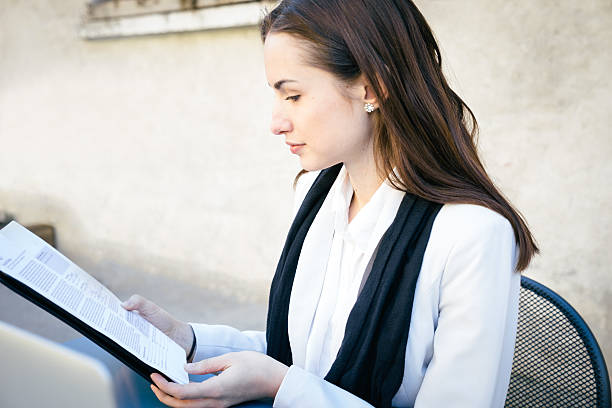 istock Cheerful Businesswoman Reading Documents 468386192