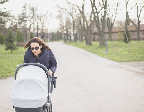 istock Mother with her baby in a stroller spending time together 468388670