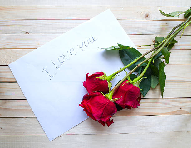 istock Red roses on a wooden table 468388758
