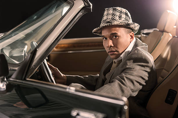 istock Serious African American retro man in an old timer car. 468388808
