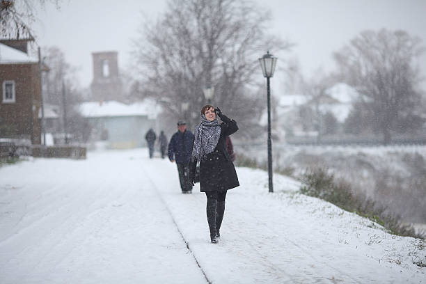 istock woman walking in a small town snow 468393138