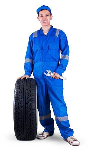 istock Friendly mechanic with a tire and wrench 468393334
