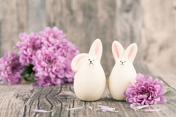istock Purple flowers surround two Easter eggs shaped like bunnies 468393994