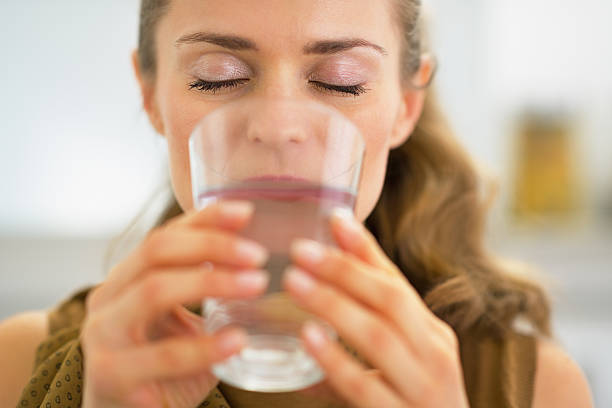 istock young housewife drinking water 468394171