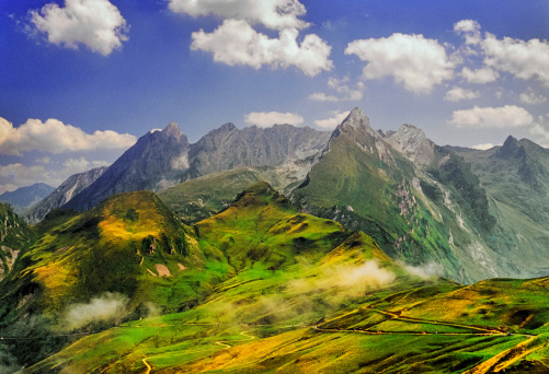 mountain landscape with grassy meadow. view in to the distant rural valley. sunny summer morning