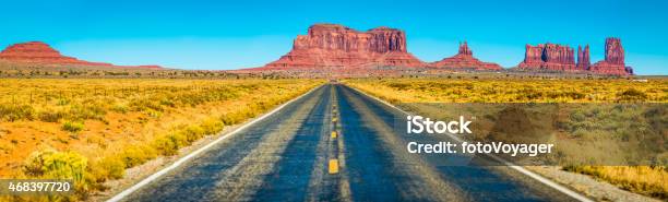 Monument Valley Long Straight Desert Road Rocky Buttes Panorama Utah Stock Photo - Download Image Now