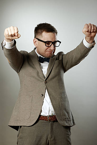 istock Confident nerd in eyeglasses and bow tie enjoying success 468397886