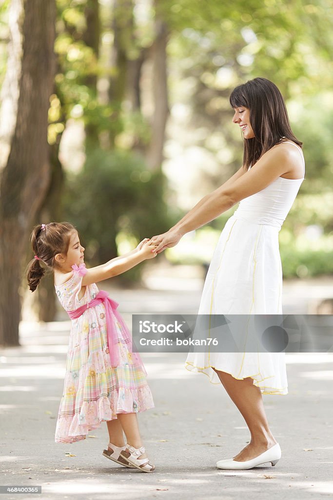 Mother and daughter Mother and little daughter having fun in a park on a nice sunny day. Active Lifestyle Stock Photo