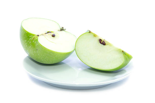 istock Fresh sliced apple with seed on white plate 468400436