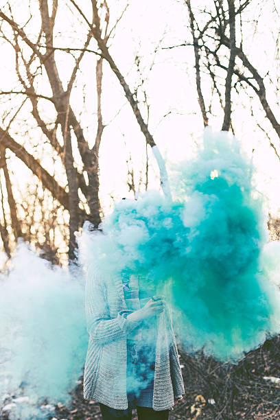 istock Hipster girls holding blue smoke 468400538