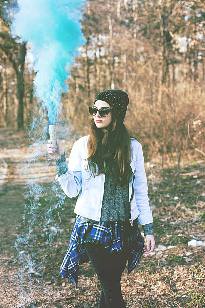 istock Hipster girls holding blue smoke 468400550