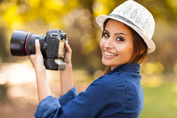 Photo of young woman learning to use camera