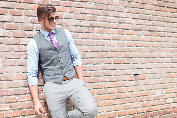 istock casual man leans on wall with hand in pocket 468402009