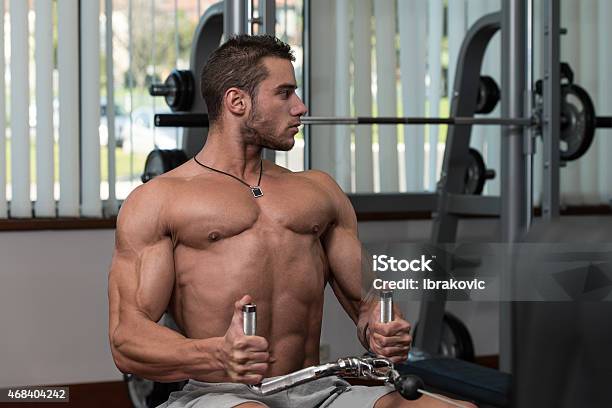 Young Man Doing Back Exercises In The Gym Stock Photo - Download Image Now - 2015, Abdominal Muscle, Active Lifestyle