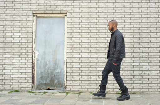 Portrait of an urban African American male fashion model walking