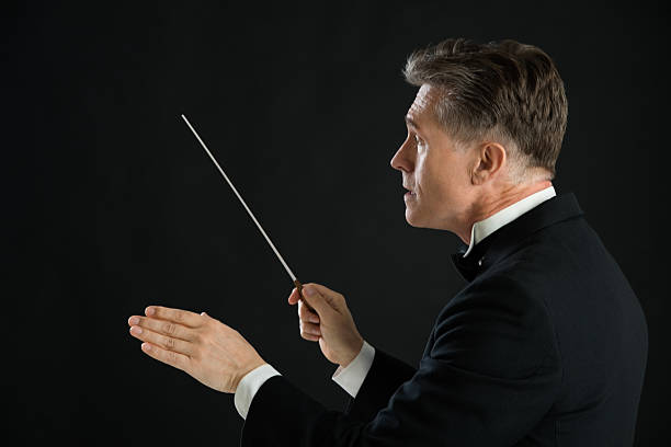 istock Male Orchestra Conductor Directing With His Baton 468405773