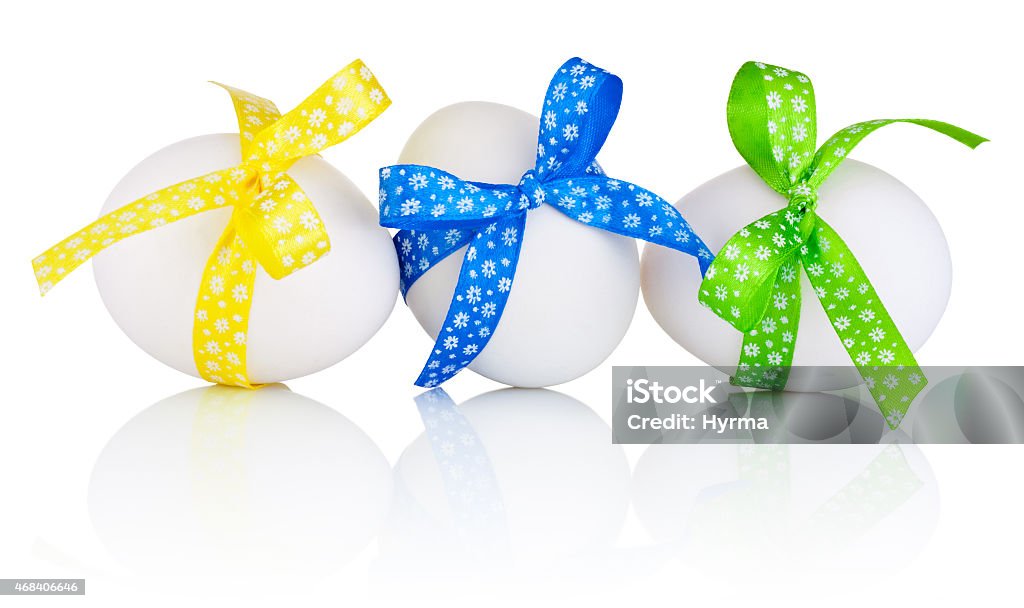 Three Easter eggs with festive bow isolated on white background 2015 Stock Photo