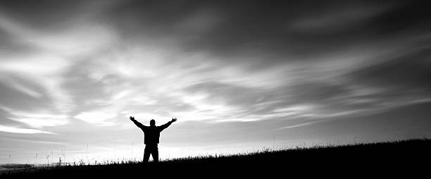 istock Panoramic view of a sillhouetted man worshiping 468410012