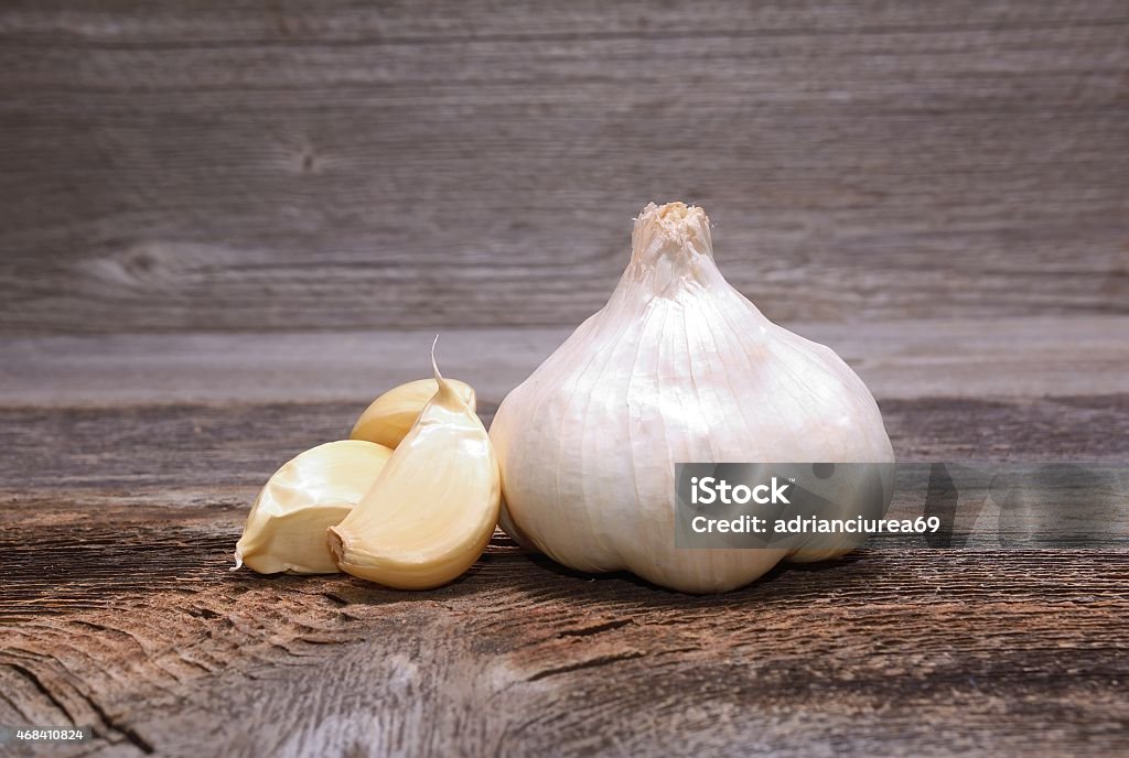 Garlic on wooden background Garlic on wooden background in studio 2015 Stock Photo