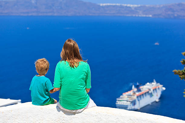 istock family looking at Santorini, Greece 468412473