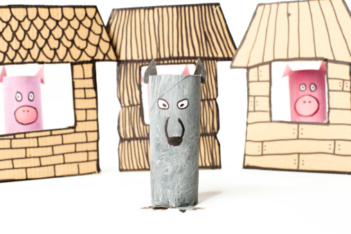 Cardboard made 3 little pigs story. Pigs and wolf. Straw, stricks and bricks houses.