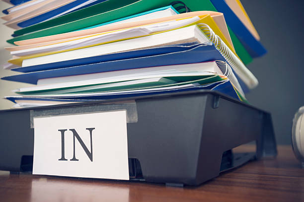istock Large stack of paperwork and files with in tray. 468413962