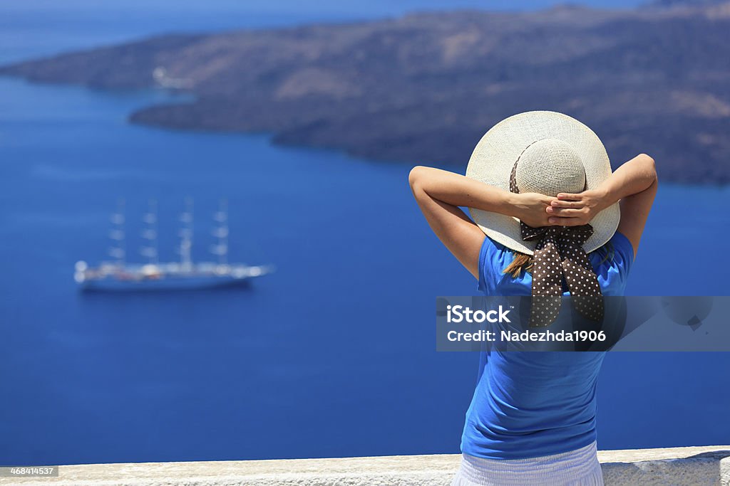 young woman enjoying view of Santorini, Greece Adult Stock Photo