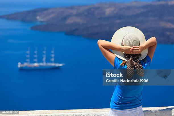 Young Woman Enjoying View Of Santorini Greece Stock Photo - Download Image Now - Adult, Aegean Sea, Balcony