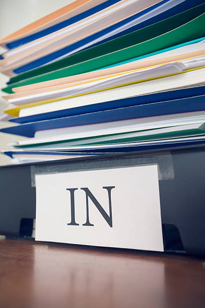 istock Large stack of paperwork and files with in tray. 468417042