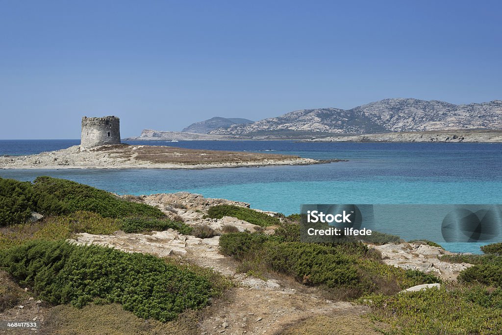 Stintino in Sardinia, Italy. La Pelosa beach and Aragonese tower in Stintino, Sardinia, Italy. Blue Stock Photo