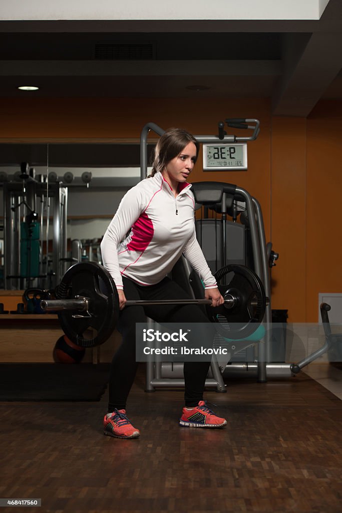 Healthy Young woman Doing Exercise For Back Young Woman Doing Heavy Weight Exercise For Back 20-29 Years Stock Photo