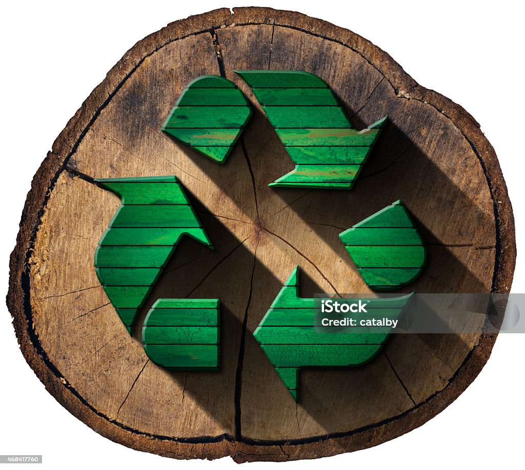 Recycle Symbol on Tree Trunk Green wooden recycling symbol on a section of tree trunk isolated on white background. Recycling Stock Photo