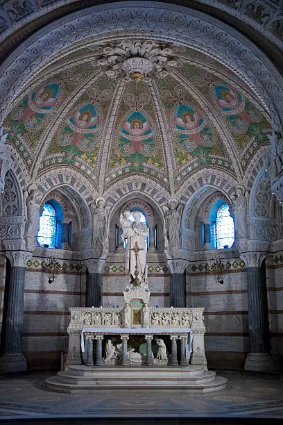statue and painted vault in the crypt of notre dame de fourviere, world heritage of unesco
