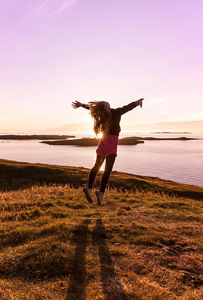 Girl dancing in the sunset Young girl jumping in a beautiful sunset religion sunbeam one person children only stock pictures, royalty-free photos & images