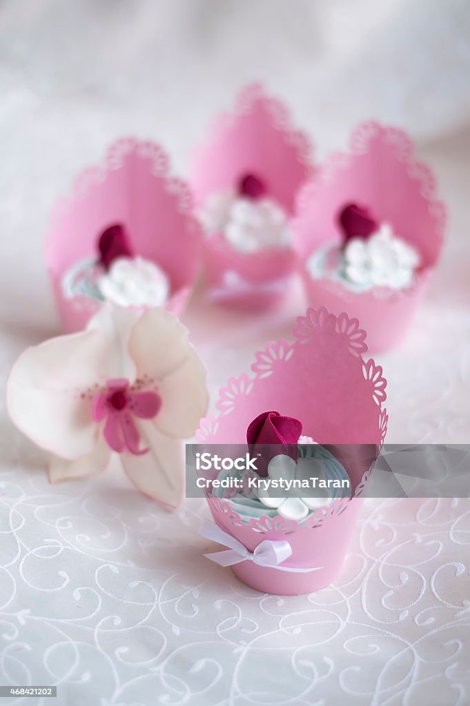 pink cupcakes decorated with cream and roses pink cupcakes decorated with roses 2015 Stock Photo
