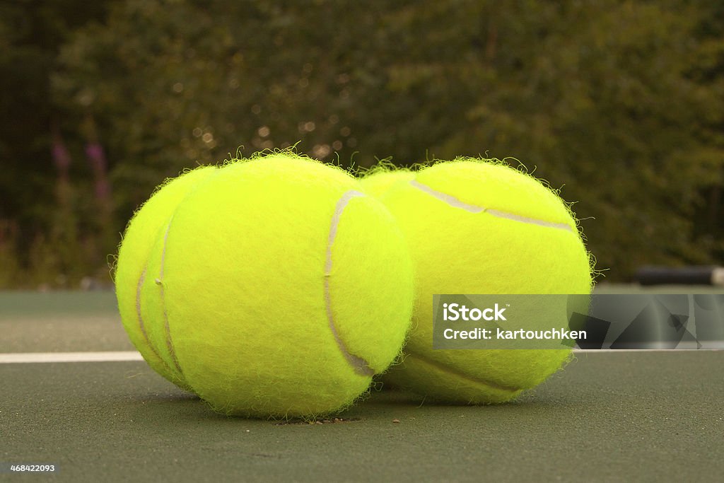 Yellow Tennis Balls - 16 New yellow tennis balls on a green court Activity Stock Photo