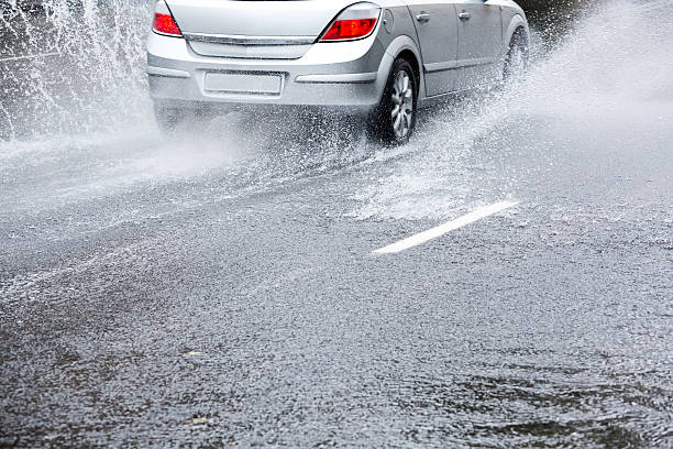 Heavy rain Car on very wet road puddle photos stock pictures, royalty-free photos & images