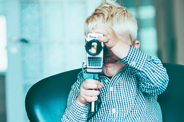 istock Child is creative with old video camera and makes movie 468424762