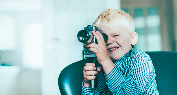 istock Boy shoots a video with an old video camera 468424766