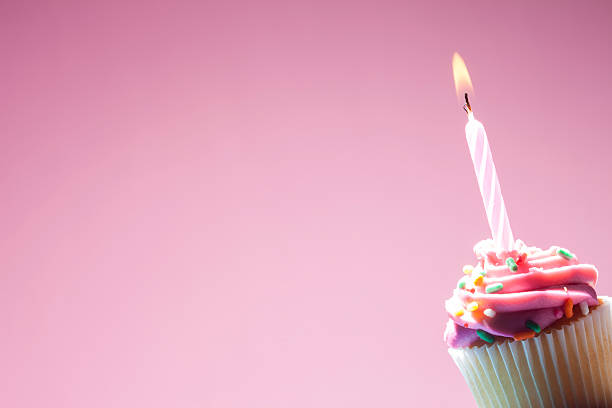 istock pink Birthday cupcake on pink background 468425516