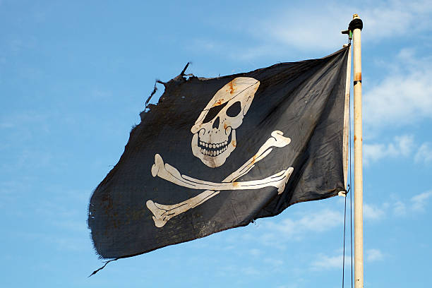 istock Pirate flag in the wind against a blue sky 468426205